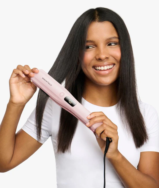 Woman styling her hair with the pink Steam Sesh straightener